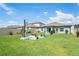 Expansive backyard with lush green grass, patio area, and well-maintained landscaping at 3611 Natural Trace St, Plant City, FL 33565