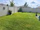Spacious backyard with lush lawn, planters and a white fence offering privacy and a serene outdoor living space at 3611 Natural Trace St, Plant City, FL 33565