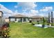 Spacious backyard with lush lawn, garden, patio area, and privacy fence, perfect for outdoor entertaining at 3611 Natural Trace St, Plant City, FL 33565