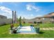 Inviting backyard patio area surrounded by lush greenery and a well-manicured lawn at 3611 Natural Trace St, Plant City, FL 33565