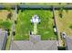 Aerial view of a well-maintained backyard with manicured lawn, white fence, and a stone patio at 3611 Natural Trace St, Plant City, FL 33565