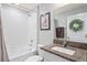 Cozy bathroom features a shower and tub combination, framed art, and a granite countertop at 3611 Natural Trace St, Plant City, FL 33565