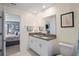 Bathroom boasts double sinks, granite countertops, and an open doorway to the main bedroom at 3611 Natural Trace St, Plant City, FL 33565