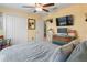 Cozy bedroom with a queen bed, ceiling fan, closet and lots of natural light at 3611 Natural Trace St, Plant City, FL 33565