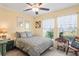 Bright bedroom features large windows, a ceiling fan, and coordinated decor, creating a cozy retreat at 3611 Natural Trace St, Plant City, FL 33565