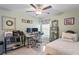 Versatile bedroom featuring a modern ceiling fan, a functional desk space, and comfortable furnishings at 3611 Natural Trace St, Plant City, FL 33565