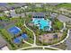 Aerial view of a community featuring a pool, clubhouse, tennis and basketball courts, and a playground at 3611 Natural Trace St, Plant City, FL 33565