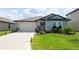 Beautiful single-Gathering home featuring a well-manicured lawn and a spacious two-car garage at 3611 Natural Trace St, Plant City, FL 33565