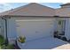 Spacious two car garage with decorative carriage hardware featuring new roof and beautiful landscaping at 3611 Natural Trace St, Plant City, FL 33565