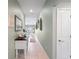 Long hallway with tile flooring and stylish decor that leads into the dining and living spaces at 3611 Natural Trace St, Plant City, FL 33565