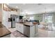 Open concept kitchen featuring granite countertops, stainless appliances, and a breakfast bar at 3611 Natural Trace St, Plant City, FL 33565