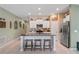 Kitchen island with granite countertops, white cabinets, and stainless steel appliances enhance this modern kitchen at 3611 Natural Trace St, Plant City, FL 33565