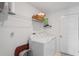 Functional laundry room with washer, dryer, and shelving at 3611 Natural Trace St, Plant City, FL 33565