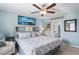 Light-filled main bedroom with a decorative ceiling fan, a king bed, and an en suite bathroom at 3611 Natural Trace St, Plant City, FL 33565