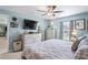 Serene main bedroom with a modern ceiling fan, plush bedding, and views to the living area at 3611 Natural Trace St, Plant City, FL 33565