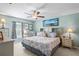 Bright main bedroom featuring an elegant ceiling fan, a king bed, and a wall-mounted television at 3611 Natural Trace St, Plant City, FL 33565