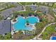 Aerial view of the community pool area featuring a winding pool with a splash pad and seating at 3611 Natural Trace St, Plant City, FL 33565