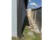 Narrow side yard with stepping stones and partial fencing at 3611 Natural Trace St, Plant City, FL 33565