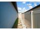 Narrow side yard with stone pavers, landscaping rocks, and a vinyl privacy fence at 3611 Natural Trace St, Plant City, FL 33565