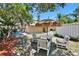 Backyard with a covered patio, a table and seating area under a tiki umbrella at 3626 S Hesperides St, Tampa, FL 33629