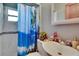 Bright bathroom featuring tiled walls, updated sink, and tropical themed shower curtain at 3626 S Hesperides St, Tampa, FL 33629