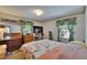 Bedroom with floral bedding, dresser, and natural light, creating a cozy and inviting space at 3626 S Hesperides St, Tampa, FL 33629