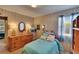 Inviting bedroom with a comfortable bed, wooden dresser, and natural light from the window at 3626 S Hesperides St, Tampa, FL 33629