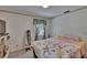 Comfortable bedroom with floral bedding, natural light, and traditional furnishings at 3626 S Hesperides St, Tampa, FL 33629