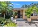 Charming home featuring a beautiful, intricately designed front door surrounded by lush landscaping at 3626 S Hesperides St, Tampa, FL 33629