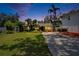 Beautiful home at dusk with a verdant front yard and a spacious driveway, perfect for evening enjoyment at 3626 S Hesperides St, Tampa, FL 33629