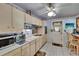 Well-lit kitchen including a breakfast bar, white appliances, and easy access to the backyard at 3626 S Hesperides St, Tampa, FL 33629