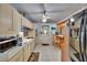 Traditional kitchen with bright tile floor, breakfast bar, and an exit door to the exterior at 3626 S Hesperides St, Tampa, FL 33629