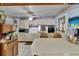Charming kitchen with a breakfast bar, neutral cabinets, white appliances, and a ceiling fan at 3626 S Hesperides St, Tampa, FL 33629