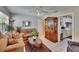 Cozy living room showcasing comfortable sofas, a vintage display cabinet, and bright tile flooring at 3626 S Hesperides St, Tampa, FL 33629