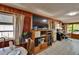 Comfortable living area with wood paneled walls and tile floor; TV entertainment center at 3626 S Hesperides St, Tampa, FL 33629