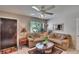 Inviting living room with plush seating, decorative accents, and a ceiling fan for added comfort at 3626 S Hesperides St, Tampa, FL 33629