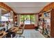 Bright office with wooden desk, shelving, and a large window overlooking the yard at 3626 S Hesperides St, Tampa, FL 33629