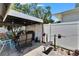 Covered patio with a dining table and an area set up for weightlifting at 3626 S Hesperides St, Tampa, FL 33629
