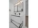 The bathroom has dual sinks, a white cabinet and black faucets at 4000 Grove S St, St Petersburg, FL 33705