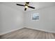 Bright bedroom featuring light gray vinyl floors, a ceiling fan, and a window at 4000 Grove S St, St Petersburg, FL 33705