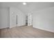 This is a simple bedroom with neutral walls and wood floors leading to other rooms at 4000 Grove S St, St Petersburg, FL 33705