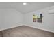 A simple bedroom with neutral walls, wood floors and a ceiling fan at 4000 Grove S St, St Petersburg, FL 33705