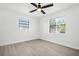 Bright, airy bedroom with ceiling fan, sleek flooring, and multiple large windows at 4000 Grove S St, St Petersburg, FL 33705