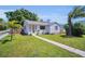 Charming single-story home featuring a well-maintained lawn and inviting walkway at 4000 Grove S St, St Petersburg, FL 33705