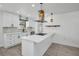Modern white kitchen with an island cooktop, designer backsplash, and stainless appliances at 4000 Grove S St, St Petersburg, FL 33705