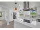 Beautiful white kitchen with stainless appliances, island cooktop and eat in kitchen space at 4000 Grove S St, St Petersburg, FL 33705