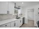 Updated kitchen with shaker cabinets, quartz counters, and stainless steel dishwasher at 4000 Grove S St, St Petersburg, FL 33705