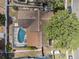 Aerial view of the property showcasing the screened-in pool, patio, and lush greenery at 4120 Tyndale Dr, Brandon, FL 33511