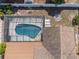 Aerial view of the backyard featuring a screened-in pool and a cozy fire pit area at 4120 Tyndale Dr, Brandon, FL 33511