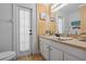 Well-lit bathroom with a white vanity, decorative nautical accents, and a door to the outside at 4120 Tyndale Dr, Brandon, FL 33511